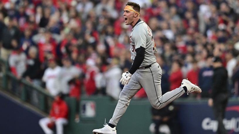 Detroit Tigers' Kerry Carpenter celebrates as he runs the bases with a three-run home run in the ninth inning during Game 2 of baseball's AL Division Series against the Cleveland Guardians, Monday, Oct. 7, 2024, in Cleveland. (AP Photo/David Dermer)