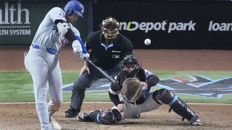 Los Angeles Dodgers' Shohei Ohtani (17) hits a home run scoring Andy Pages, during the seventh inning of a baseball game against the Miami Marlins, Thursday, Sept. 19, 2024, in Miami. (AP Photo/Wilfredo Lee)