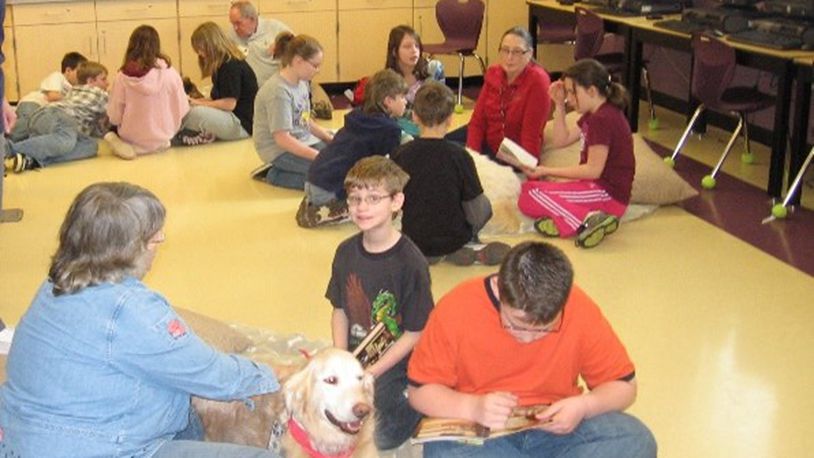 The Mechanicsburg Public Library's PAWS for Reading program, which is celebrating 20 years, over the years since it started in 2003. Contributed