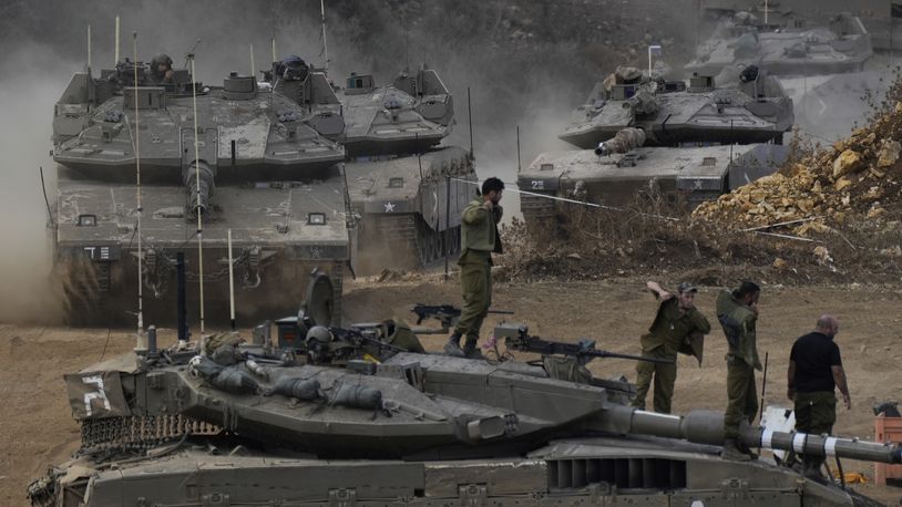 Israeli army tanks manoeuvre in a staging area in northern Israel near the Israel-Lebanon border, Tuesday, Oct. 1, 2024. (AP Photo/Baz Ratner)