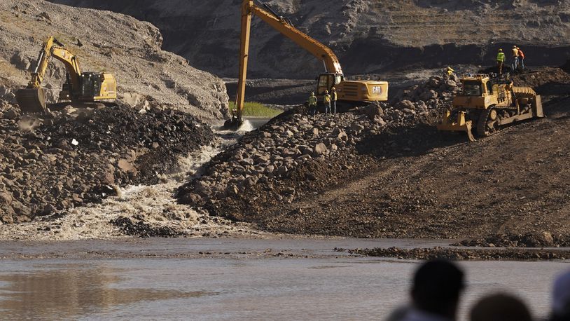 This image provided by Matthew John Mais shows crews working at the Iron Gate cofferdam site along the Klamath River on Wednesday, Aug. 28, 2024, in Siskiyou County, Calif. (Matthew John Mais via AP)