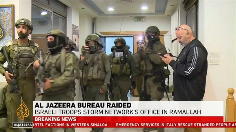 This image made from video provided by Al Jazeera English shows Israeli troops raiding their bureau in Ramallah, West Bank, Sunday, Sept. 22, 2024. (Al Jazeera via AP)