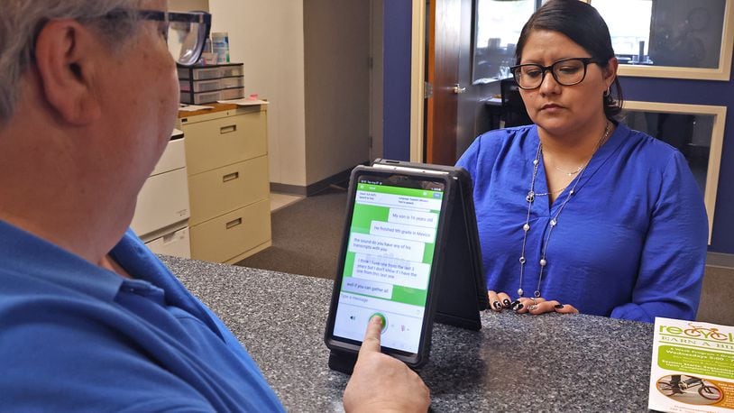 Dr. Pamela Shay and Lydia Martinez uses one of the Translate Live devices to have a conversation in the Springfield School District's central registration office Tuesday, August 27, 2024. BILL LACKEY/STAFF