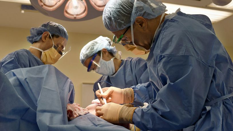 FILE - Surgeons perform a bilateral mastectomy on a transgender patient at a hospital in Boston on Friday, July 15, 2016. On Wednesday, July 3, 2024, a U.S. federal district court judge temporarily halted parts of a nondiscrimination rule that would have kept insurers and medical professionals from denying hormone therapy, gender transition surgeries and similar medical care for transgender people. (Christine Hochkeppel/Worcester Telegram & Gazette via AP, File)