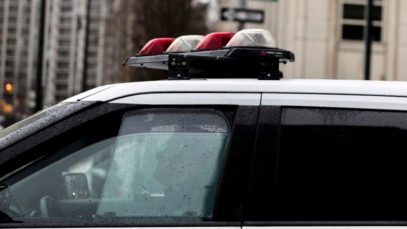 FILE - A police officer sits in a car near the Brooklyn Bridge, Dec. 16, 2022, in the Brooklyn borough of New York. (AP Photo/Julia Nikhinson, file)