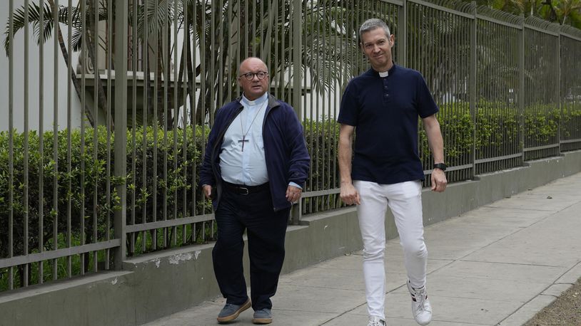 FILE - Vatican investigators Monsignor Jordi Bertomeu, right, from Spain, and Archbishop Charles Scicluna, from Malta, walk outside of the Nunciatura Apostolica during a break from meeting with people who alleged abuse by the Catholic lay group Sodalitium Christianae Vitae in Lima, Peru, on July 25, 2023. (AP Photo/Martin Mejia, File)