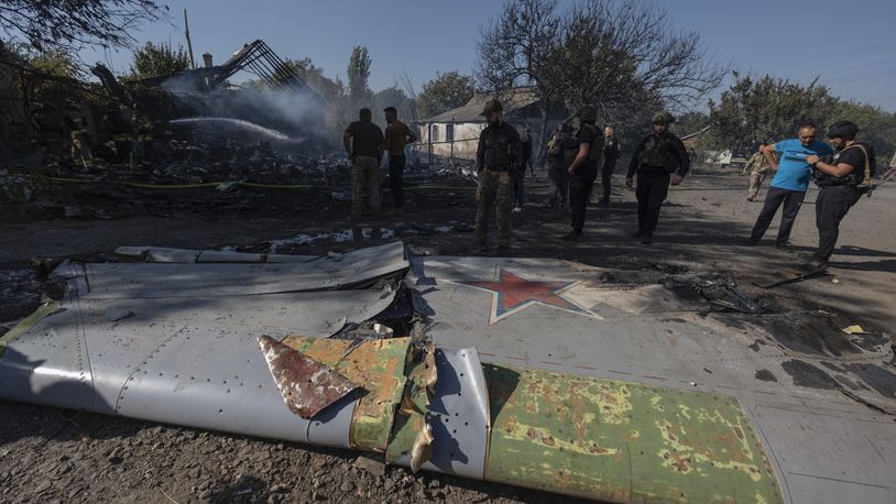 Ukrainian servicemen examine fragments of a Russian military plane that was shot down on the outskirts of Kostyantynivka, a near-front line city in the Donetsk region, Ukraine, Saturday, Oct. 5, 2024. (Iryna Rybakova via AP)