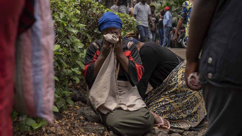 Women grieve at the port of Goma, Democratic Republic of Congo, after a ferry carrying hundreds capsized on arrival Thursday, Oct. 3, 2024. (AP Photo/Moses Sawasawa)