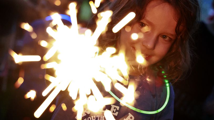 Rowan Irick, 4, plays with a sparkler Monday, July 3, 2023 at Ferncliff Cemetery before the Buck Creek Boom fireworks show. BILL LACKEY/STAFF