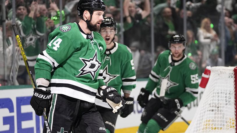 Dallas Stars left wing Jamie Benn (14), Wyatt Johnston, center, and Thomas Harley, right, celebrate after Benn scored during the first period in Game 2 of the Western Conference finals in the NHL hockey Stanley Cup playoffs against the Edmonton Oilers, Saturday, May 25, 2024, in Dallas. (AP Photo/Tony Gutierrez)