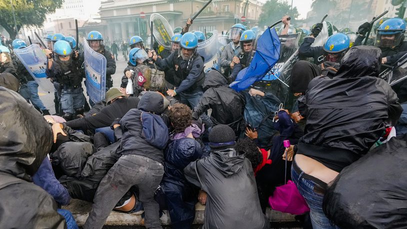 Italian Police and demonstrators clash during a march in support of the Palestinian people in Rome, Saturday, Oct. 5, 2024, two days before the anniversary of Hamas-led groups attack in Israeli territory outside of Gaza on Oct. 7, 2023. (AP Photo/Andrew Medichini)