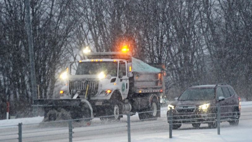 Ohio Department of Transportation trucks plow snow on I-675 near Wilmington Pike Tuesday morning, February 16, 2021.