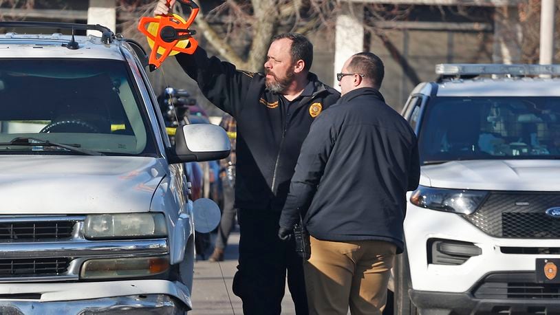 The Springfield Police Division investigate Chevy Tahoe, parked along Mason Street, where a man was found with a suspected gunshot wound to the head Tuesday, Feb. 6, 2024. BILL LACKEY/STAFF