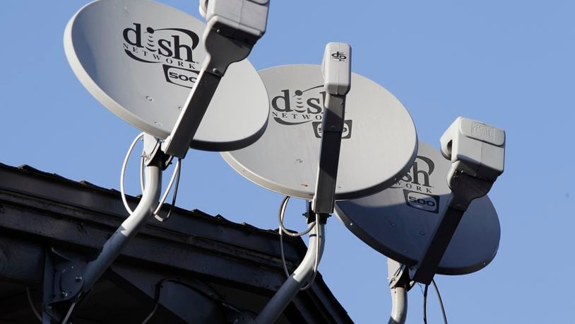 FILE - In this Feb. 23, 2011, file photo, Dish Network satellite dishes are shown at an apartment complex in Palo Alto, Calif. (AP Photo/Paul Sakuma, File)