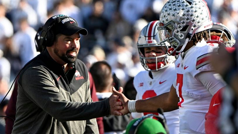 Ohio State head coach Ryan Day celebrates a touchdown with quarterback C.J. Stroud during the fourth quarter of an NCAA college football game against Penn State, Saturday, Oct. 29, 2022, in State College, Pa. Ohio State won 44-31. (AP Photo/Barry Reeger)