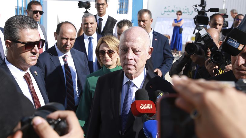 Tunisian President and candidate for re-election Kais Saied, center, and his wife Ichraf Chebil Saïed, leave a polling station after casting their votes, in Tunis, Tunisia, Sunday, Oct. 6, 2024 (AP Photo/Anis Mili)