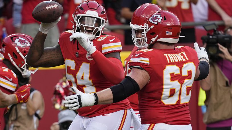 Kansas City Chiefs offensive lineman Wanya Morris, left, is congratulated by teammate Joe Thuney (62) after catching a touchdown pass during the second half of an NFL football game against the Cincinnati Bengals Sunday, Sept. 15, 2024, in Kansas City, Mo. (AP Photo/Ed Zurga)