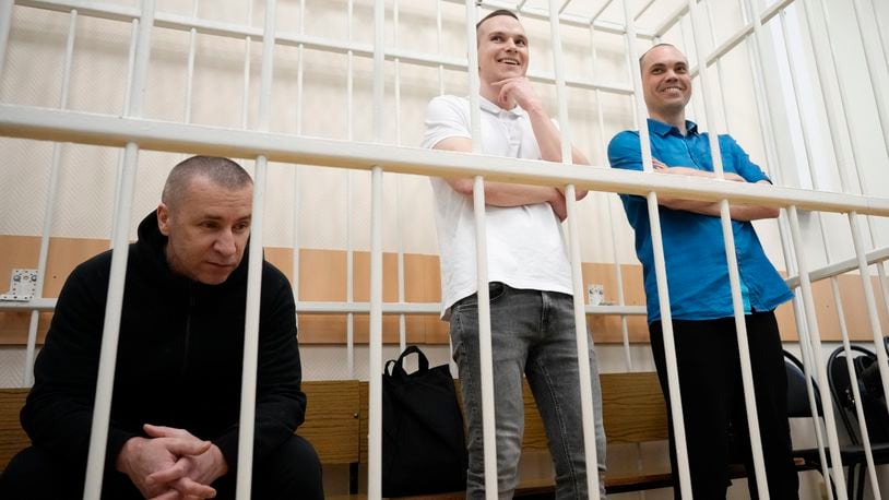 Former Navalny's lawyers Igor Sergunin, left, Alexei Liptser, center, and Vadim Kobzev, right, appear in the cage during a court session in Petushki, Vladimir region, about 120 kilometers (75 miles) east of Moscow, Russia, Thursday, Sept. 12, 2024. (AP Photo/Alexander Zemlianichenko)