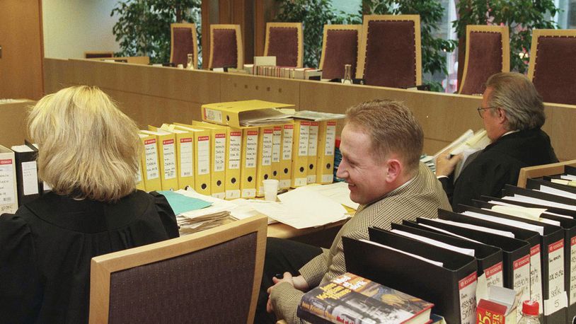 FILE - Pål Enger, center, sits in court during his appeal case, in the Borgarting Court of Appeal in Oslo, Monday, April 7, 1997. Enger, a talented Norwegian soccer player turned gentleman art thief who pulled off the sensational 1994 heist of Edvard Munch’s famed “The Scream” painting at the National Gallery in Oslo and later exhibited his abstract paintings in a gallery, is dead at 57. Press officer Tina Wulf at Vålerenga Fotball, an acclaimed Oslo soccer club, told the Associated Press on Tuesday, July 2, 2024, that Enger died Saturday evening. (Bjørn Sigurdsøn/NTB Scanpix via AP, File)