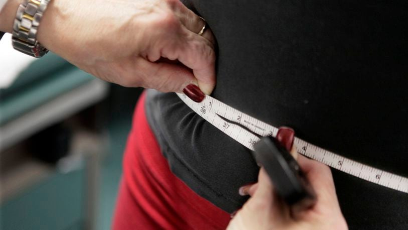 FILE - A subject's waist is measured during an obesity prevention study in Chicago on Jan. 20, 2010. (AP Photo/M. Spencer Green, File)