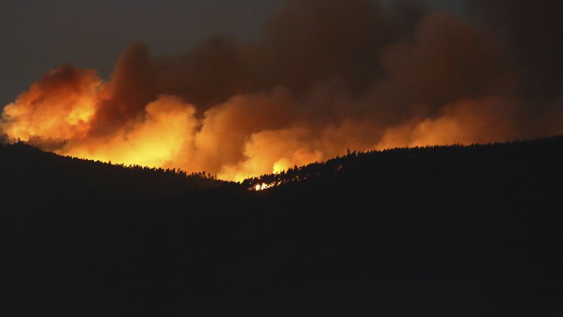 A fire rages on the hills around Sever do Vouga, a town in northern Portugal that has been surrounded by forest fires, Tuesday night, Sept. 17, 2024. (AP Photo/Bruno Fonseca)