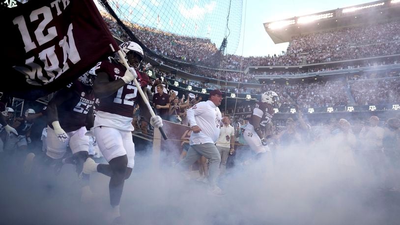 Texas A&M head coach Mike Elko leads his team on to Kyle Field for the first time against Notre Dame before the start of an NCAA college football game, Saturday, Aug. 31, 2024, in College Station, Texas. (AP Photo/Sam Craft)