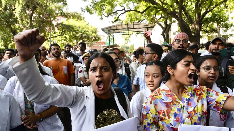 Doctors and paramedics protest against the rape and killing of a trainee doctor in Kolkata at a government hospital last week, as they gather in front of the Indian health minister's office, in New Delhi, India, Friday, Aug. 16, 2024. (AP Photo/Manish Swarup)