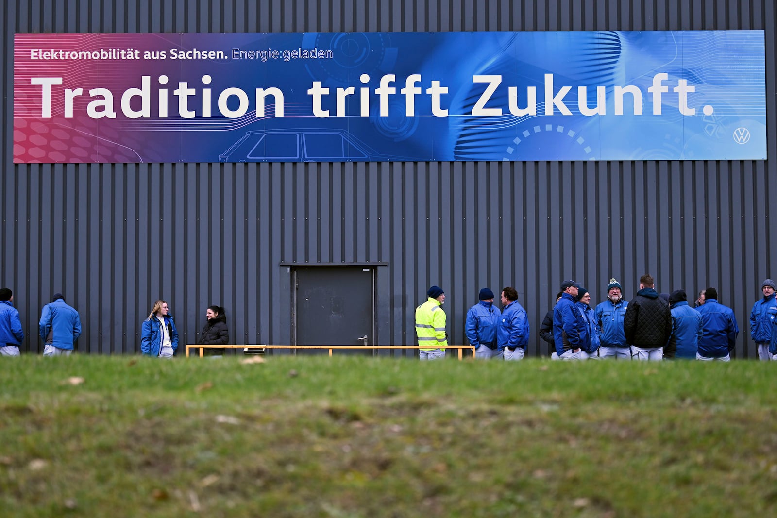 Volkswagen workers gather for a nationwide warning Volkswagen workers' strike, at the Zwickau plant, Germany, Monday, Dec. 2, 2024. Sign at top reads in German ""Tradition meets future". (Hendrik Schmidt/dpa via AP)