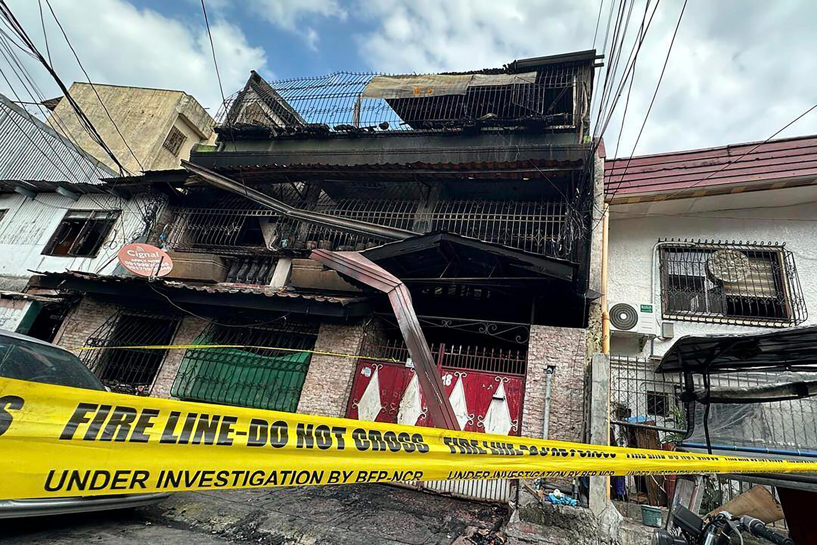 A building damaged by a fire stands in San Isidro Galas village in suburban Quezon city, Philippines Thursday, Feb. 27, 2025. (AP Photo/Joeal Calupitan)