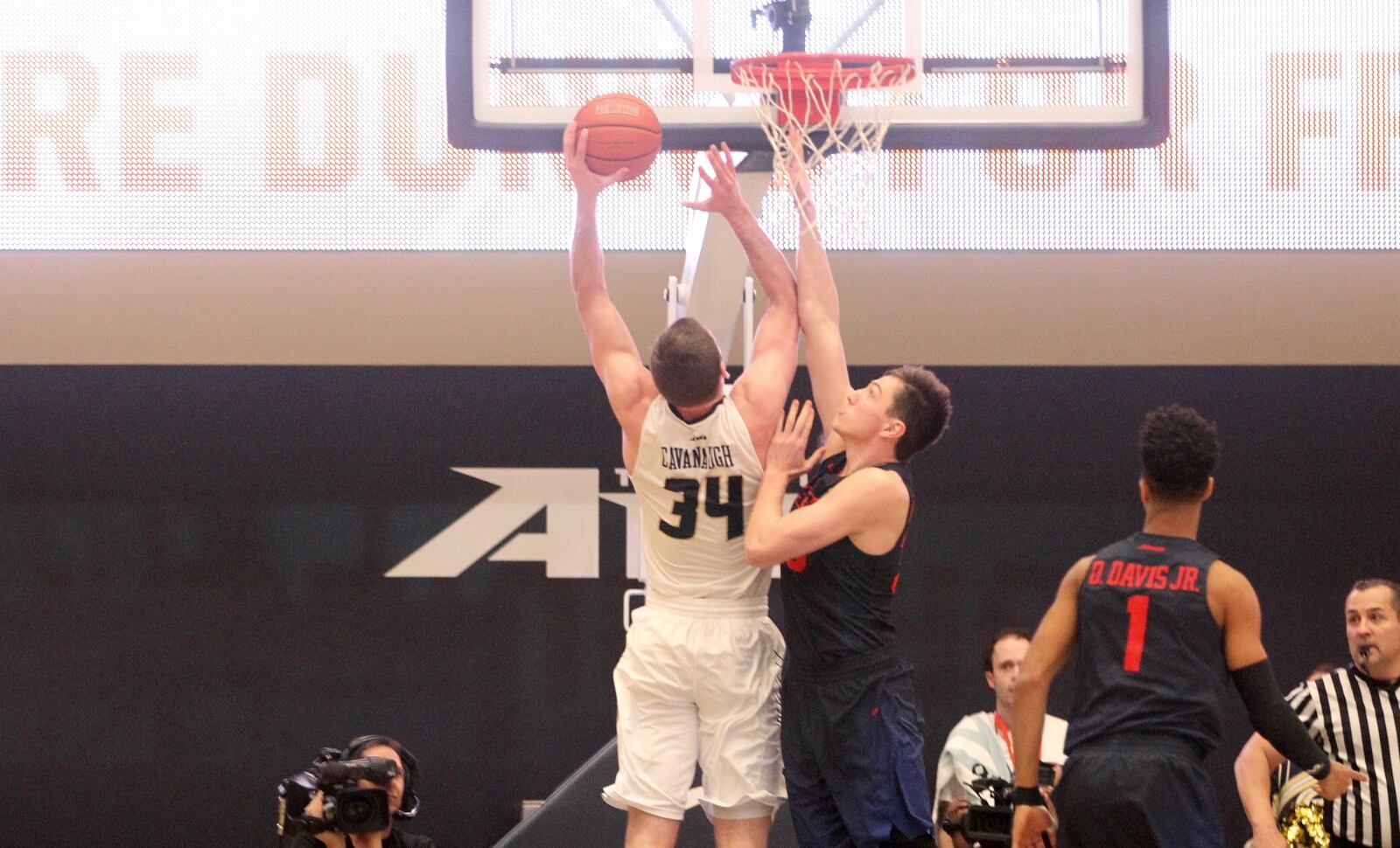 George Washington's Tyler Cavanaugh scores against Dayton's Ryan Mikesell in the opening minutes on March 4, 2017, at the Smith Center in Washington, D.C.