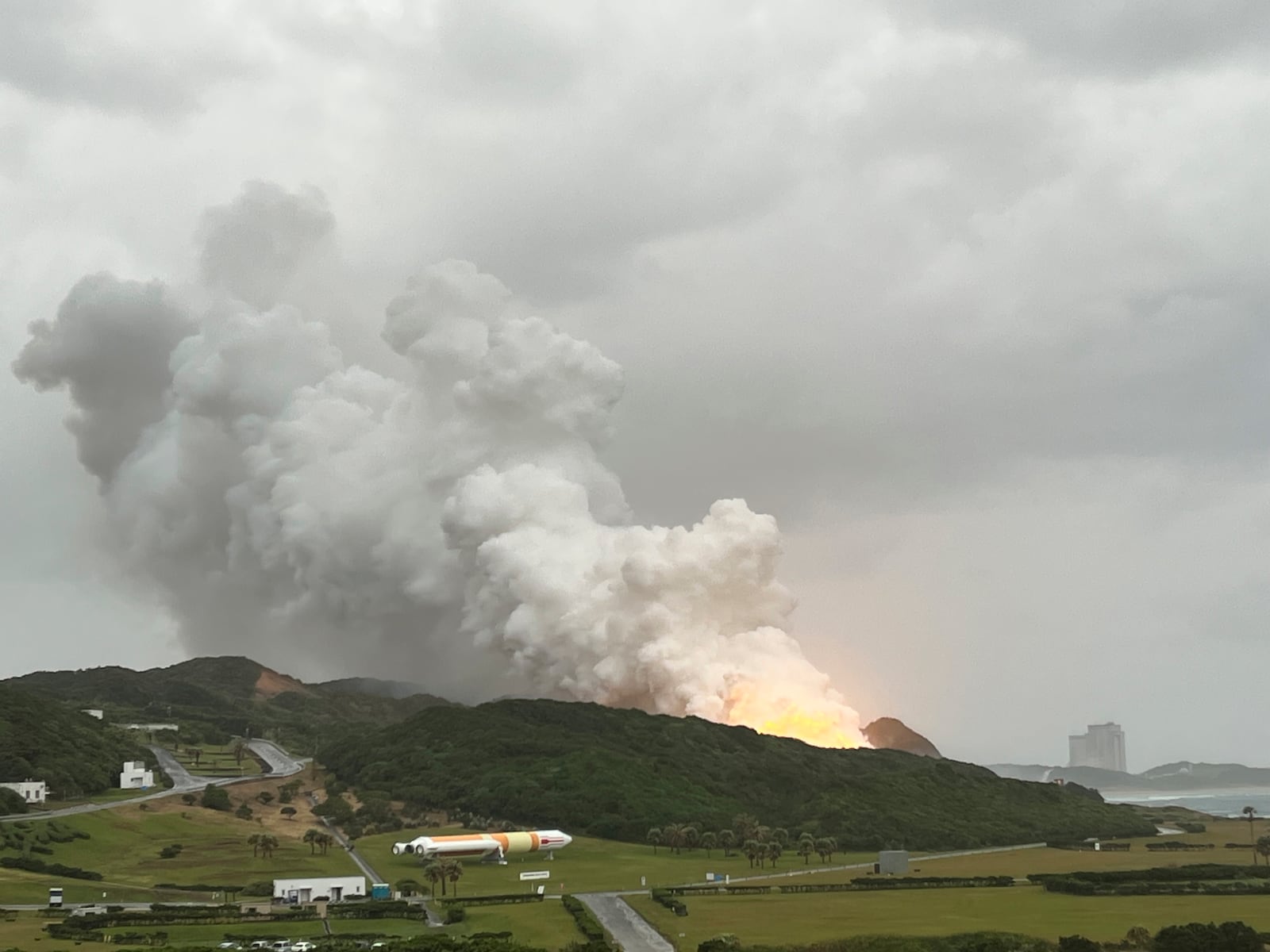 In this photo provided by Japan Aerospace Exploration Agency (JAXA), smoke billows during a combustion test of an engine for new small Japanese rocket Epsilon S at Tanegashima Space Center, in Tanegashima, Kagoshima prefecture, southern Japan, Tuesday, Nov. 26, 2024. (JAXA via AP)