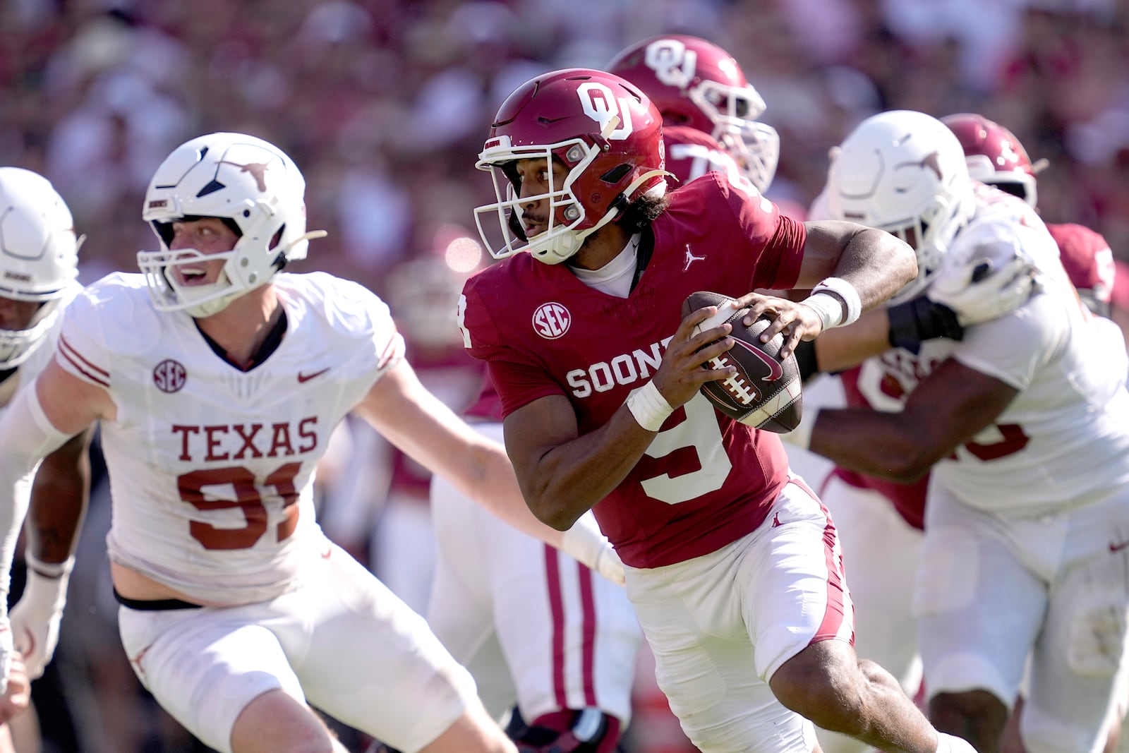 Oklahoma quarterback Michael Hawkins Jr. (9) scrambles out of the pocket in the first half of an NCAA college football game against Texas in Dallas, Saturday, Oct. 12, 2024. (AP Photo/Tony Gutierrez)