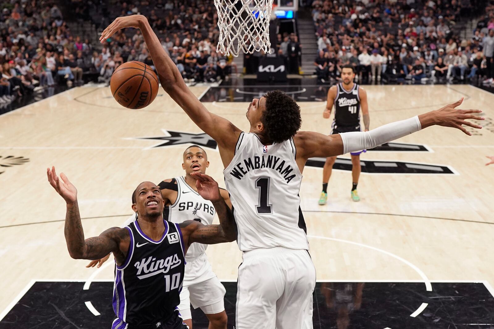 Sacramento Kings forward DeMar DeRozan (10) is blocked by San Antonio Spurs center Victor Wembanyama (1) during the first half of an NBA basketball game in San Antonio, Monday, Nov. 11, 2024. (AP Photo/Eric Gay)