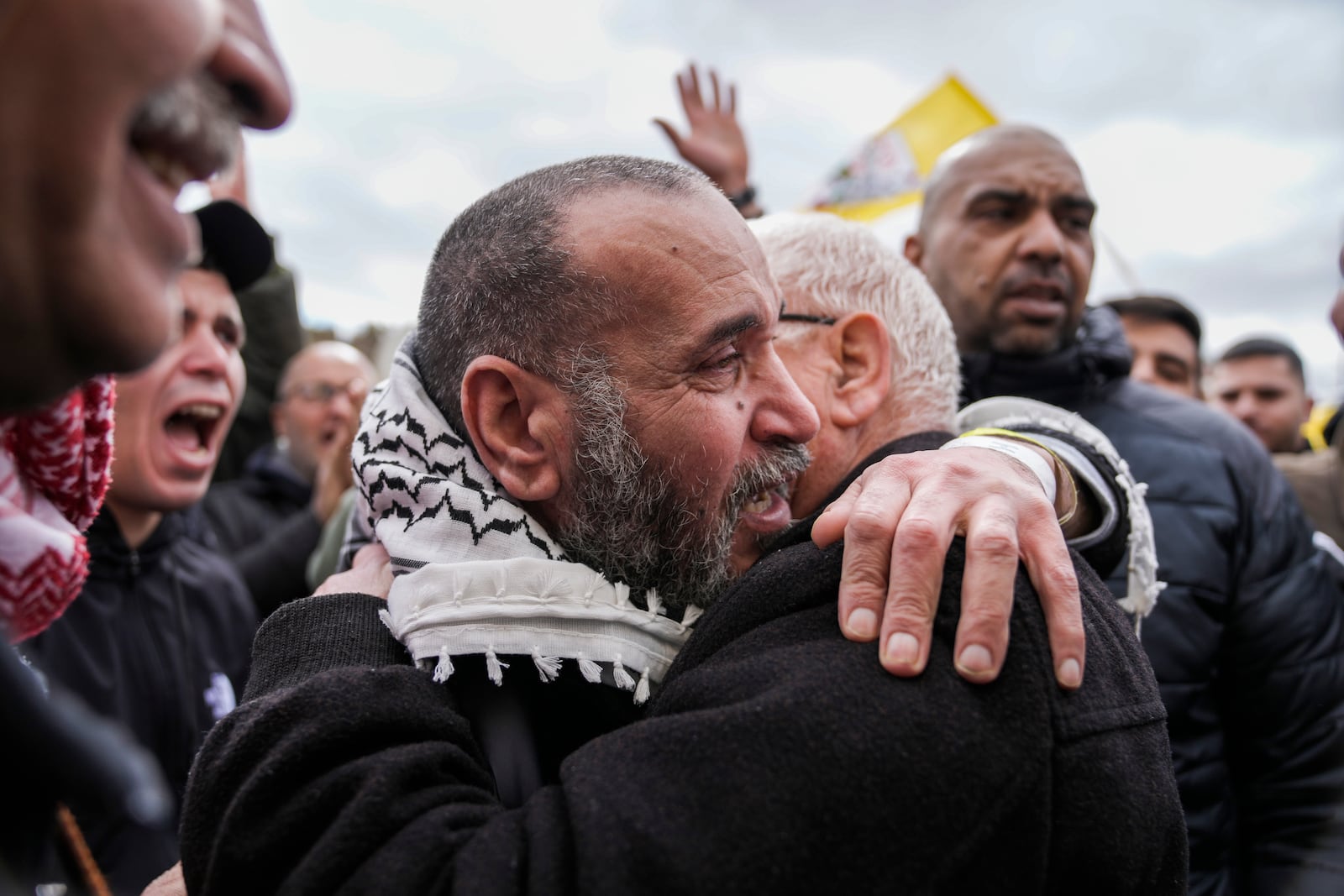 Palestinian prisoners are greeted as they exit a Red Cross bus after being released from Israeli prison following a ceasefire agreement between Israel and Hamas, in the West Bank city of Ramallah, Saturday Feb. 8, 2025. (AP Photo/Mahmoud Illean)