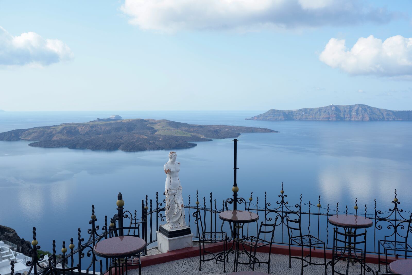 The volcanic island of Nea Kameni, left, is seen from Fira town as Greek authorities are taking emergency measures in response to intense seismic activity on the popular Aegean Sea holiday island of Santorini, southern Greece, Monday, Feb. 3, 2025. (AP Photo/Petros Giannakouris)