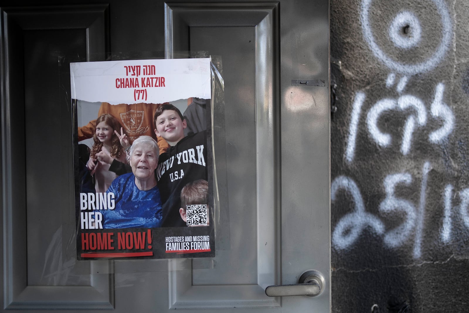 FILE - A poster calling for the release of Hannah (Chana) Katzir is taped to the door of her home in Kibbutz Nir Oz, on Nov. 21, 2023. (AP Photo/Maya Alleruzzo, File)