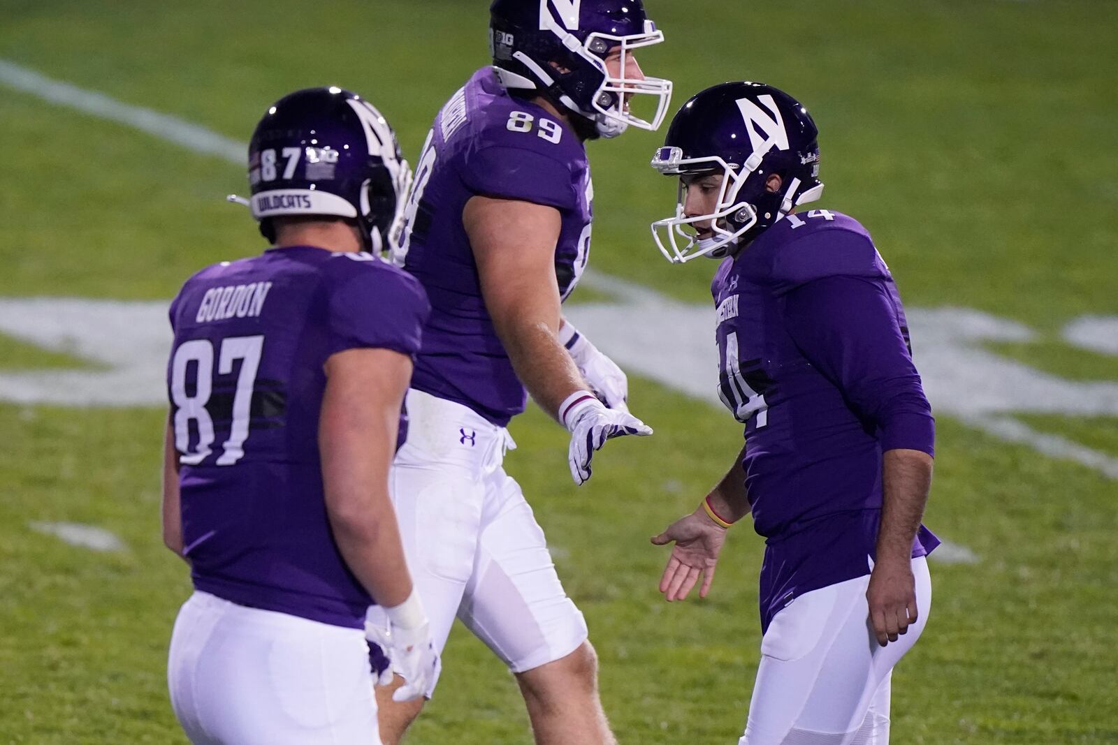 Northwestern kicker Charlie Kuhbander, right, celebrates with tight ends Jack Gordon, left, and Charlie Mangieri after kicking a field goal during the second half of an NCAA college football game against Wisconsin in Evanston, Ill., Saturday, Nov. 21, 2020. Northwestern won 17-7. (AP Photo/Nam Y. Huh)