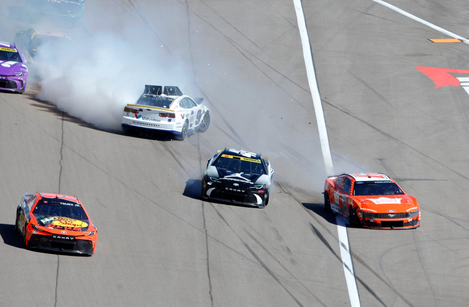 NASCAR Cup Series drivers Chase Elliott (9) Tyler Reddick (45) and Brad Keselowski (6) slide across the front straightaway after a crash during a NASCAR Cup Series auto race at the Las Vegas Motor Speedway Sunday, Oct. 20, 2024, in Las Vegas. (Steve Marcus/Las Vegas Sun via AP)