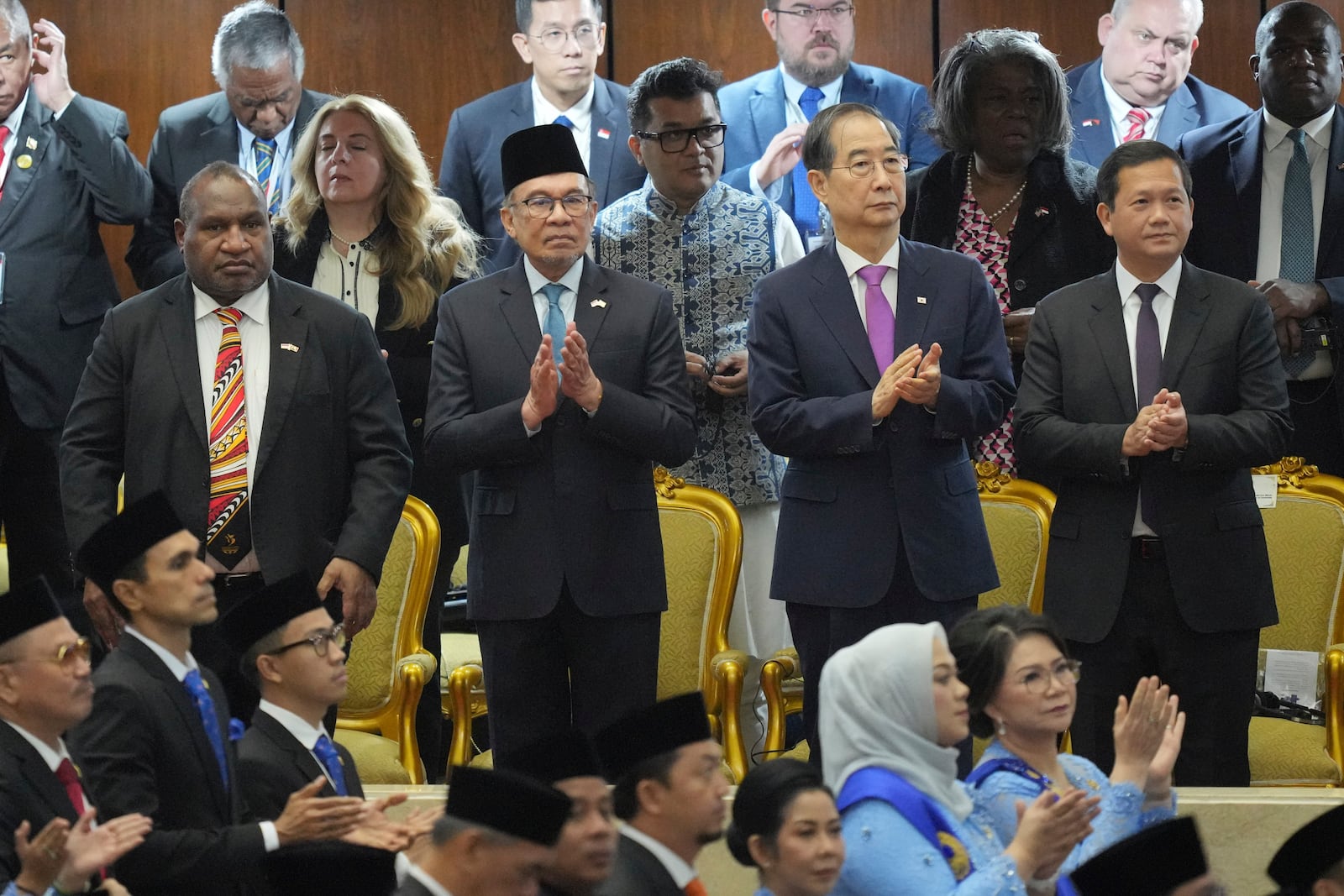 From left, Papua New Guinea's President James Marape, Malaysian Prime Minister Anwar Ibrahim, South Korea's Prime Minister Han Duck Soo, and Cambodian Prime Minister Hun Manet applaud as they attend the swearing in ceremony of Indonesia's new President Prabowo Subianto at the parliament building in Jakarta, Indonesia, Sunday, Oct. 20, 2024. (AP Photo/Tatan Syuflana)