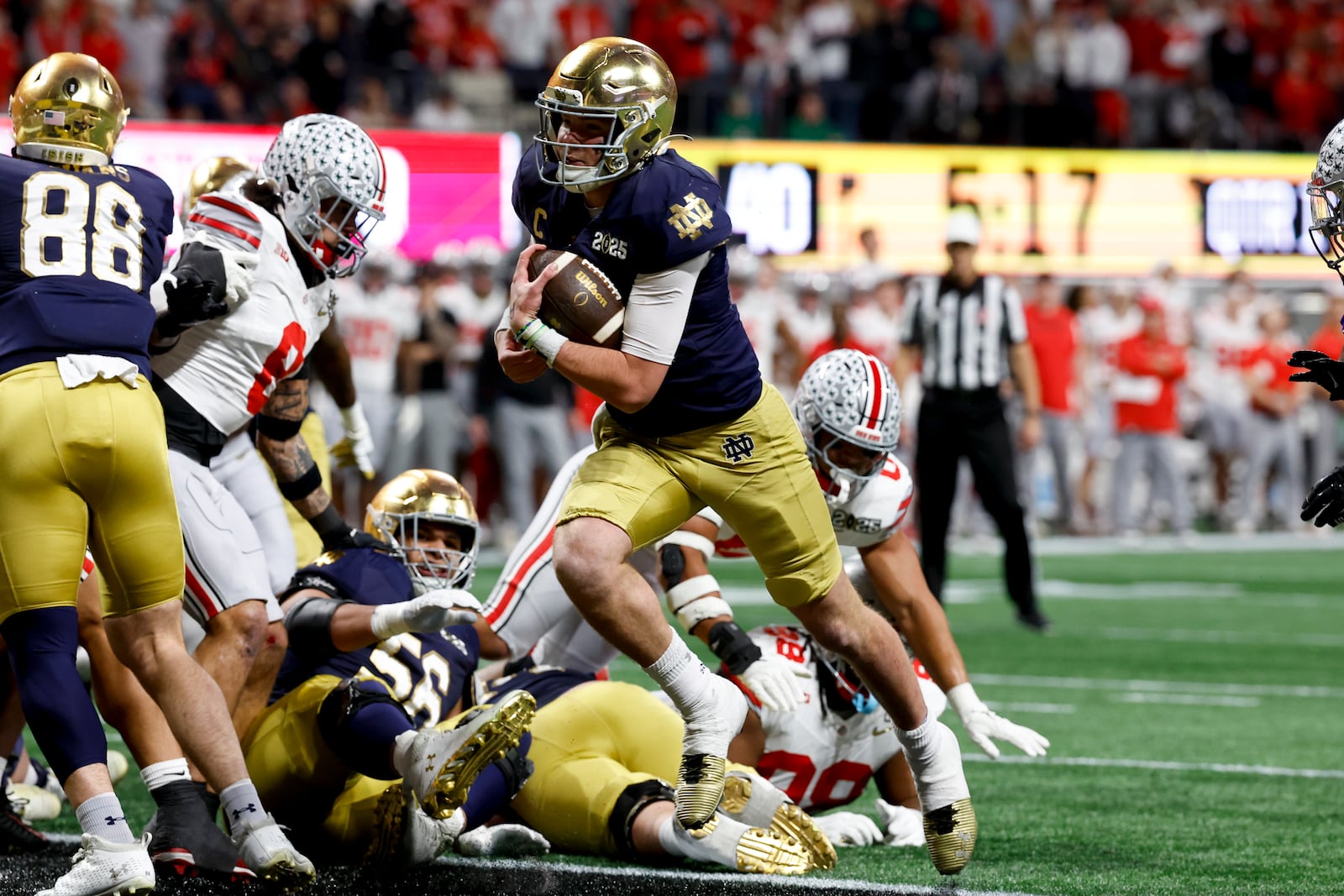 Notre Dame quarterback Riley Leonard runs for a touchdown against Ohio State during first half of the College Football Playoff national championship game Monday, Jan. 20, 2025, in Atlanta. (AP Photo/Butch Dill)