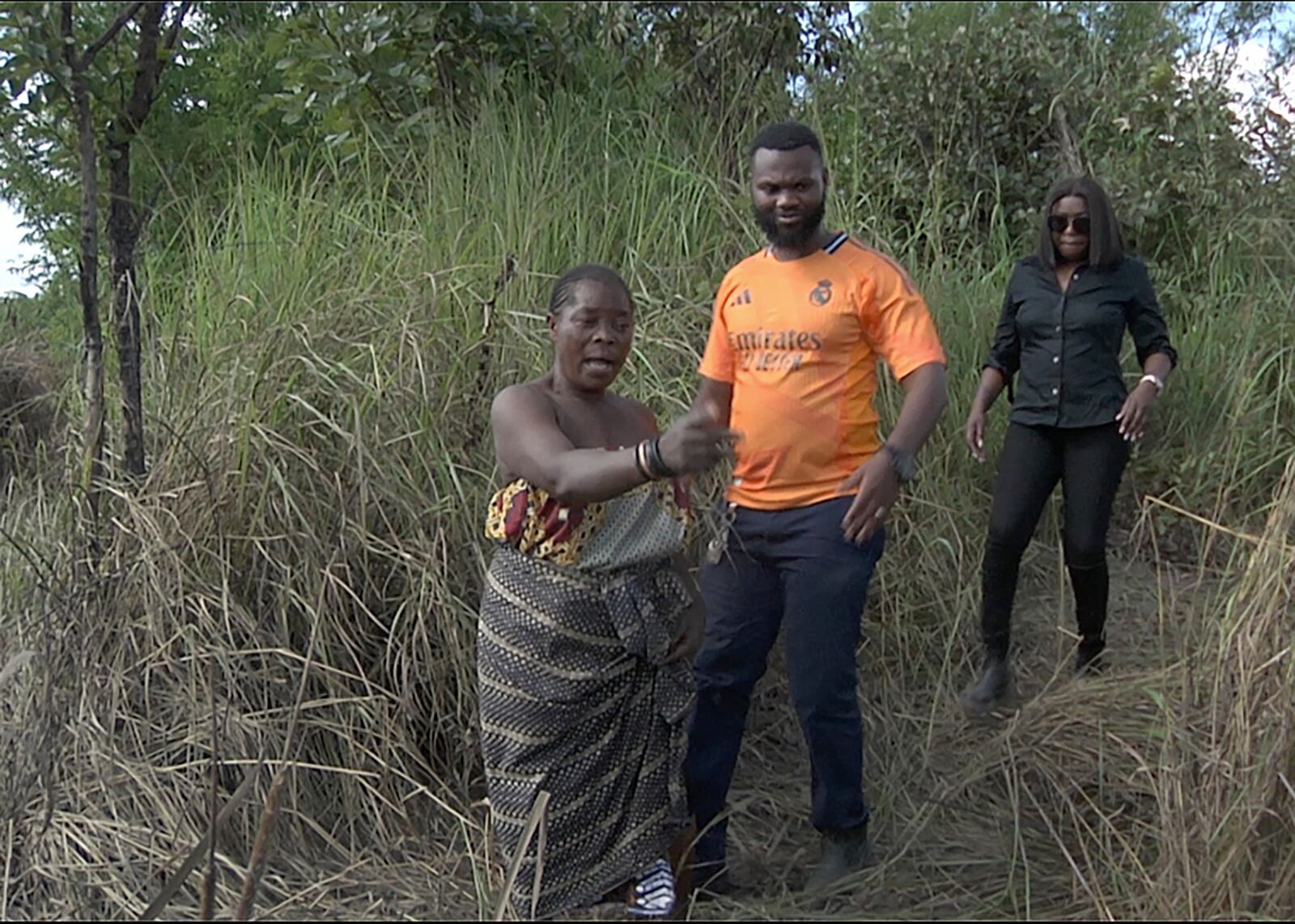 This image taken from video Wednesday, Feb. 19, 2025, shows farmer Juliet Balaya as she surveys the damage to her crop and fishpond caused by a mine waste spill near Kitwe. (AP Photo/Richard Kille )