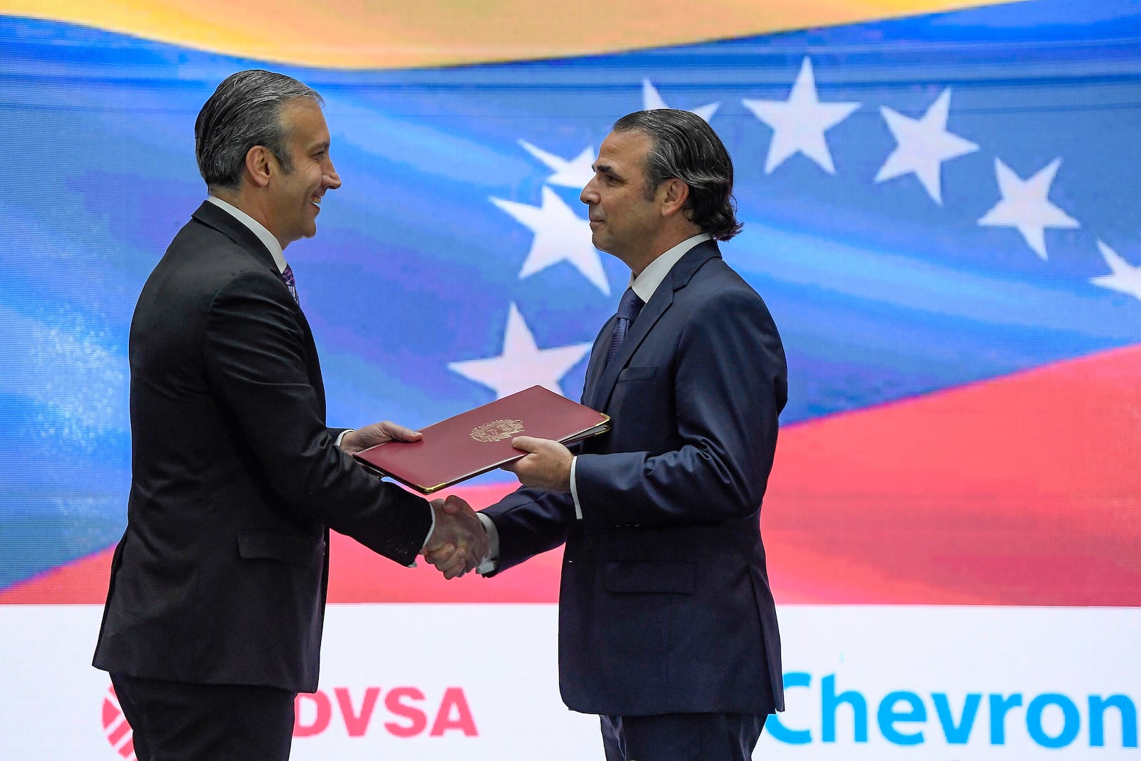 FILE - Venezuelan's then Oil Minister Tareck El Aissami, left, shakes hands with then Chevron President in Venezuela, Javier La Rosa, during an agreement signing ceremony in Caracas, Venezuela, Dec. 2, 2022. (AP Photo/Matias Delacroix, File)