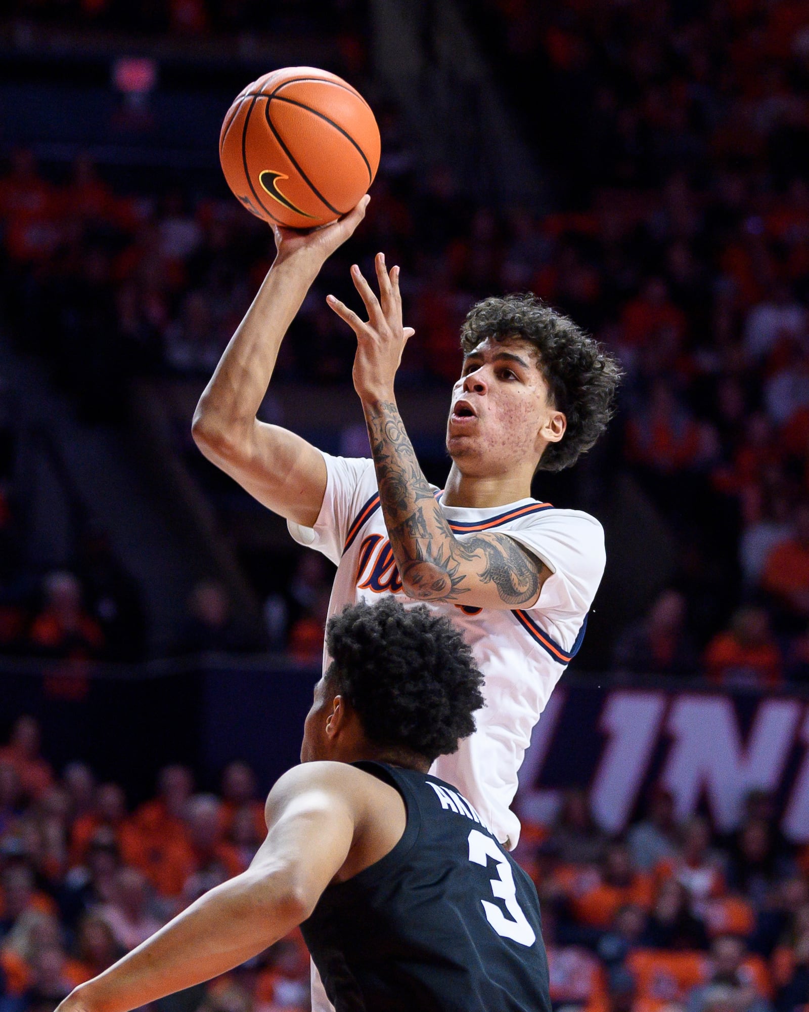 Illinois' Will Riley shoots over Michigan State's Jaden Akins during an NCAA college basketball game Saturday, Feb. 15, 2025, in Champaign, Ill. (AP Photo/Craig Pessman)