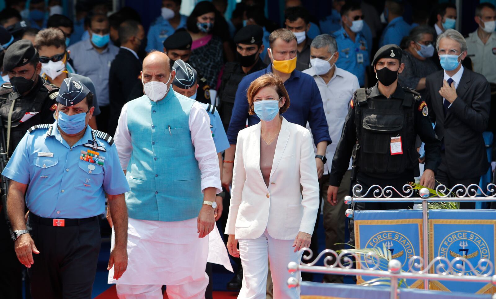 Indian Defense Minister Rajnath Singh, second left and French Defense Minister Florence Parly, right, walk during an induction ceremony of French-made Rafale fighter jets at Air Force Station Ambala, India, Thursday, Sept.10, 2020. The first batch of five planes, part of a $8.78 billion deal signed between the two countries in 2016 had arrived here in July. (AP Photo/Manish Swarup)