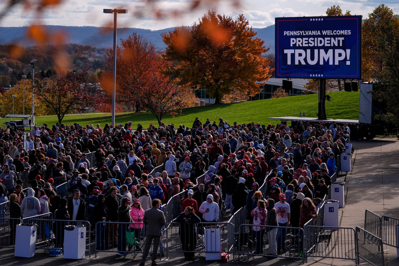 People wait in line to enter a Republican presidential nominee former President Donald Trump campaign event in State College, Pa., Saturday, Oct. 26, 2024. (AP Photo/Matt Rourke)