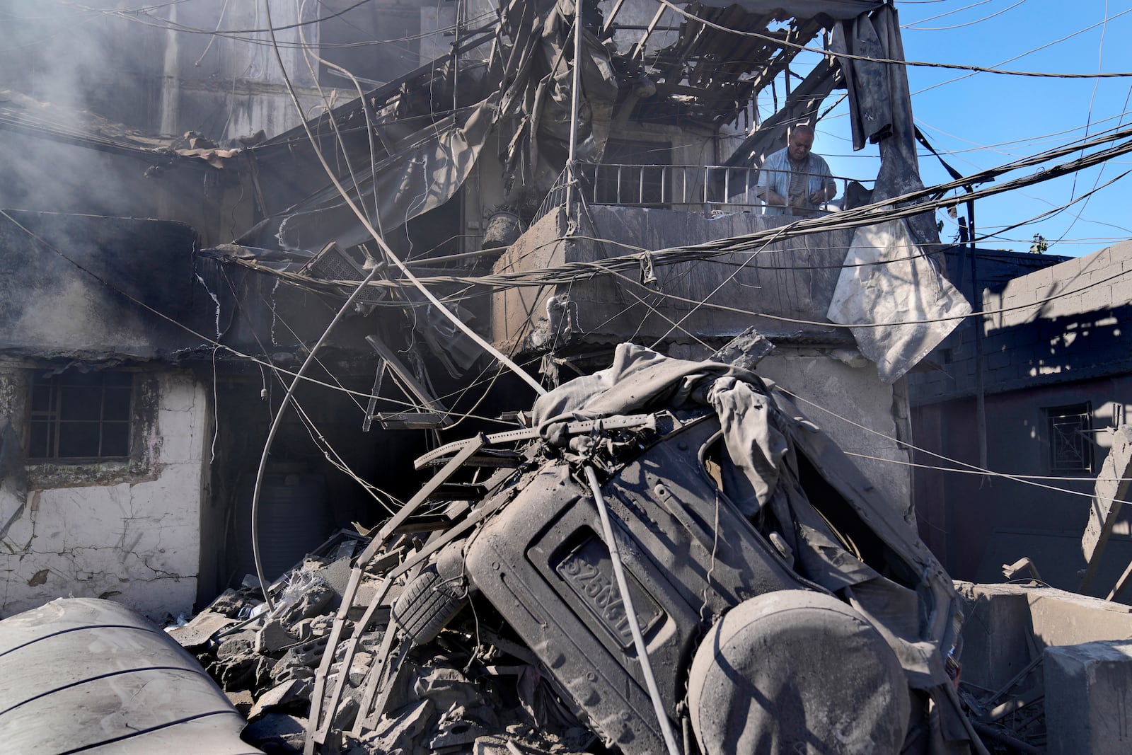 A man checks his destroyed house at the site of Israeli airstrikes that destroyed buildings facing the city's main government hospital in a densely-populated neighborhood, in southern Beirut, Lebanon, Tuesday, Oct. 22, 2024.(AP Photo/Hussein Malla)