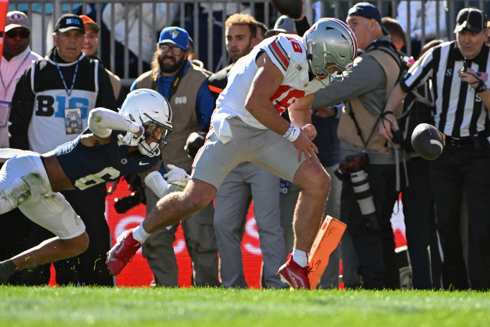 Ohio State quarterback Will Howard (18) fumbles the ball out of the end zone for a touchback while being pursued by Penn State safety Zakee Wheatley (6) during the second quarter of an NCAA college football game, Saturday, Nov. 2, 2024, in State College, Pa. (AP Photo/Barry Reeger)