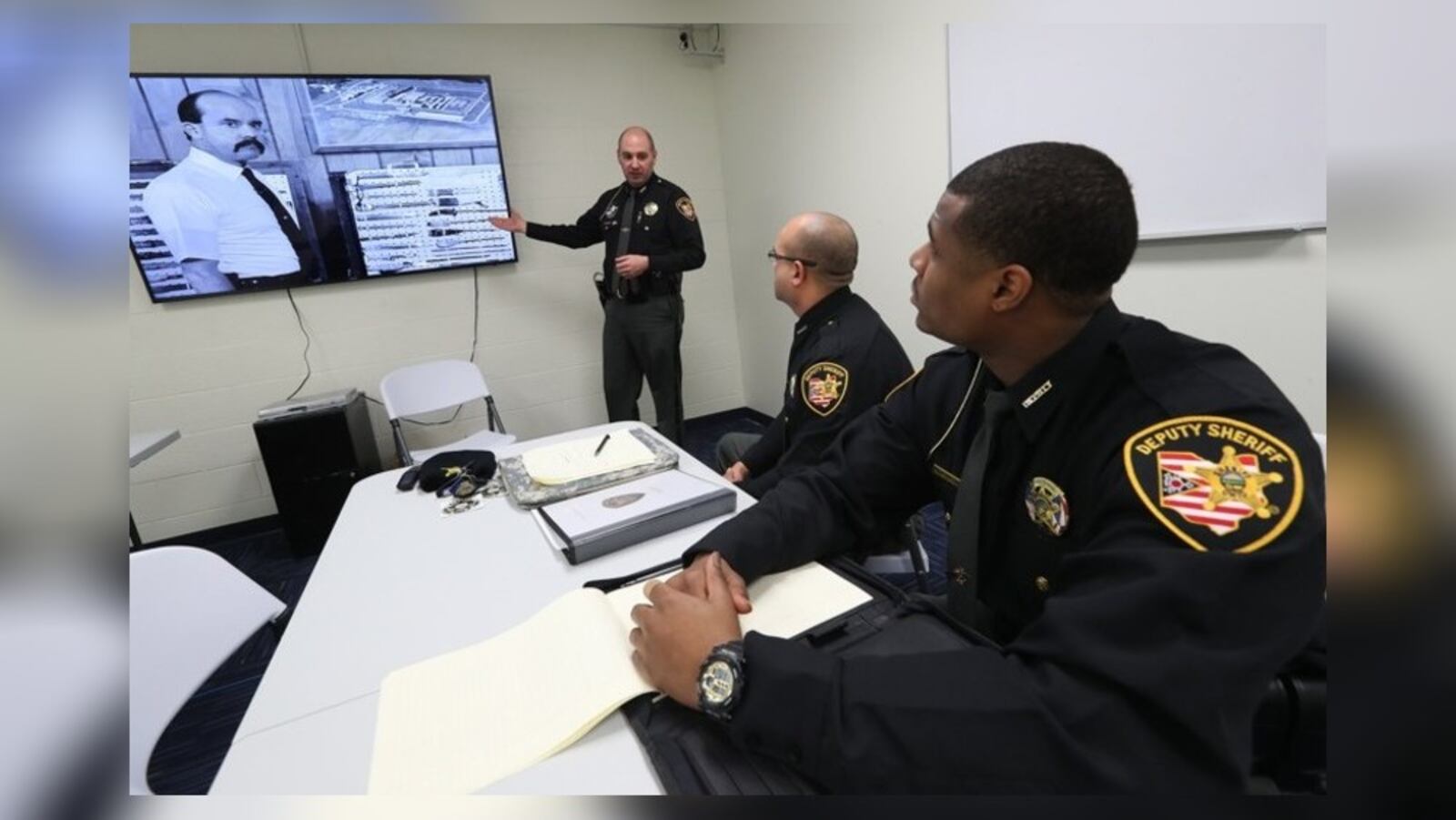 Clark County Sheriff’s deputy John Loney talks to new deputies Jordan Bean and Marcus Johnson as they watch a training video in the Clark County Jail Tuesday, Jan. 23, 2018. BILL LACKEY / STAFF