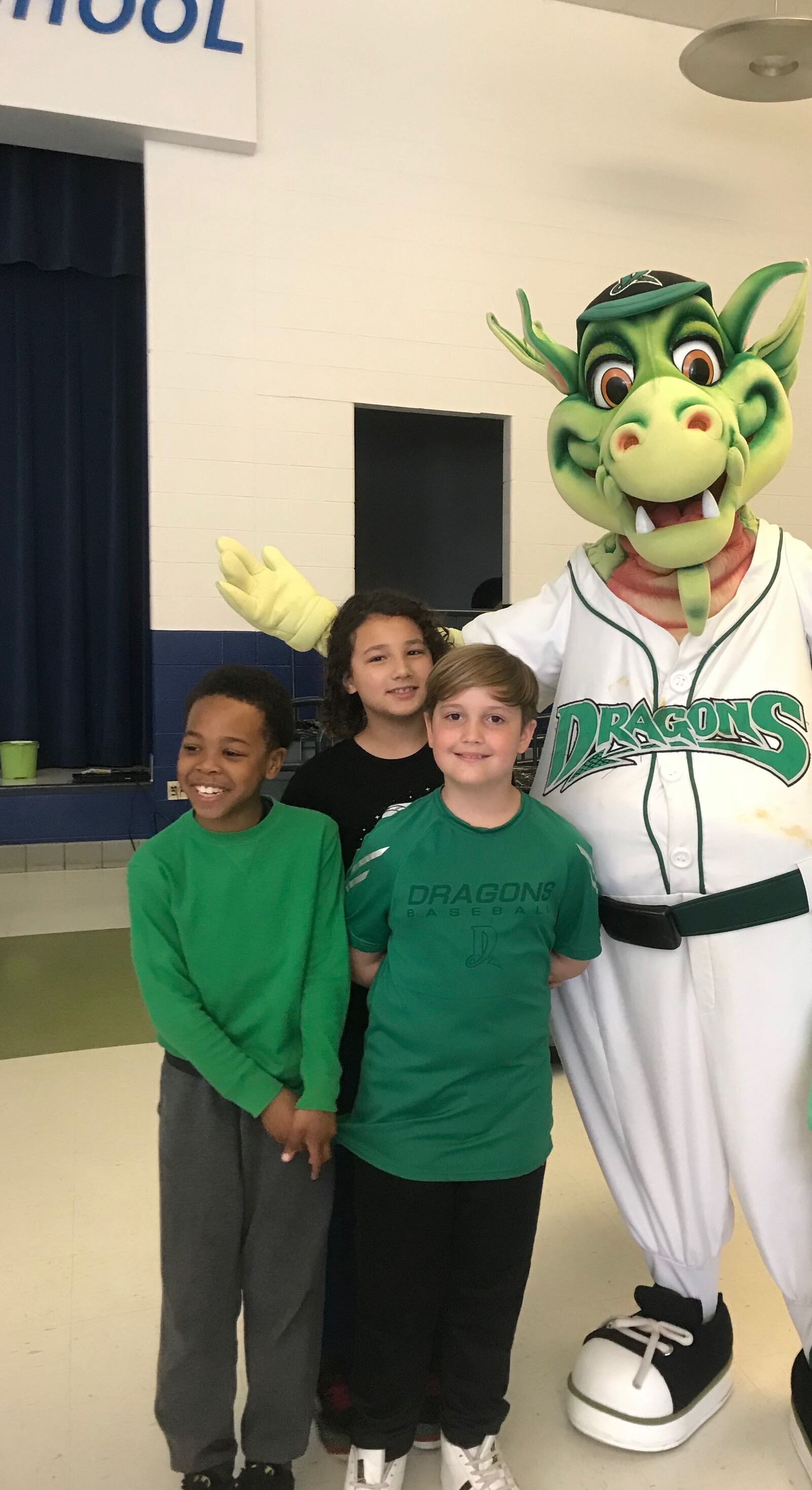 Logan Huggins (long-sleeved green shirt) Brennan Bailey (Dragons shirt) and Marc Carter (in the back) wanted to do something to help after learning about the tragic Oregon District shooting that impacted some of their classmates directly. Here, they pose with Dragons mascot Heater. CONTRIBUTED