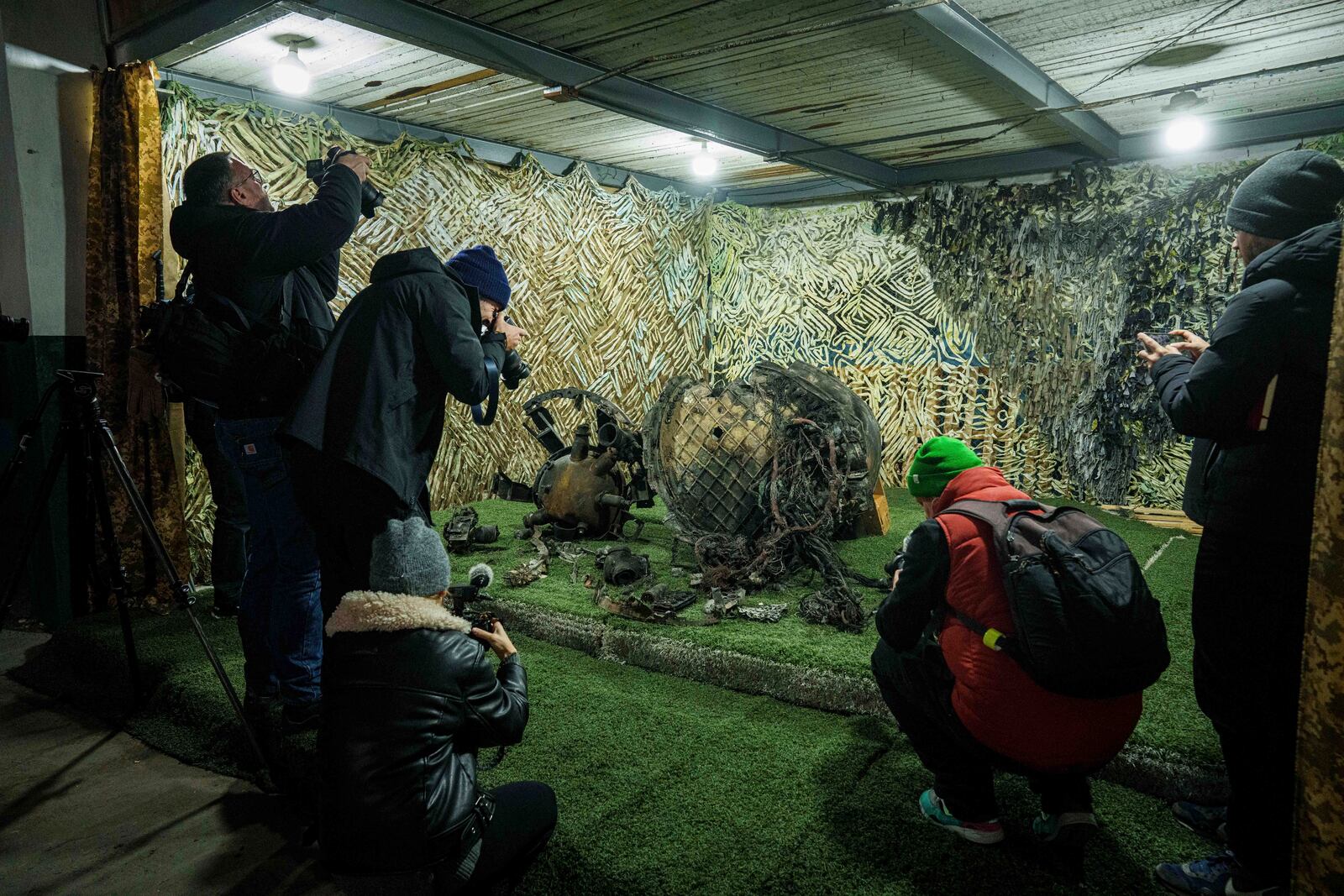 FILE - Journalists at a center for forensic analysis in an undisclosed location in Ukraine on Nov. 24, 2024, film fragments of what authorities in Kyiv described as a Russian hypersonic missile that struck a factory in Dnipro, Ukraine. (AP Photo/Evgeniy Maloletka, File)